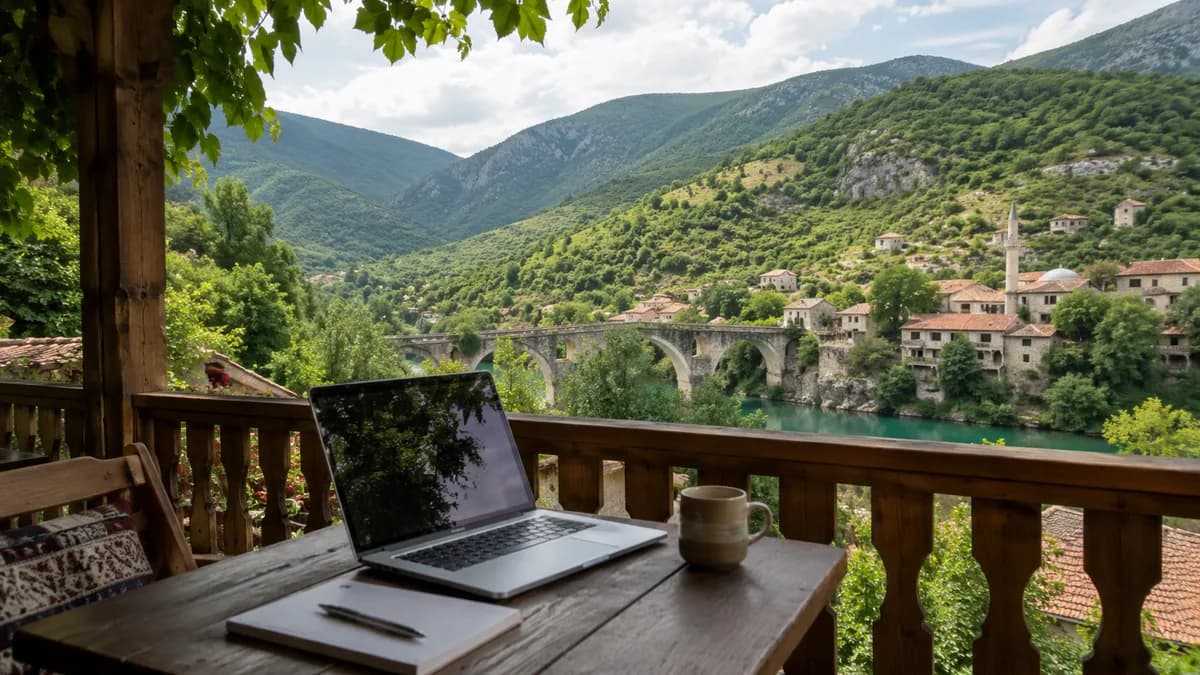 Laptop on a terrace overlooking a Bosnian valley